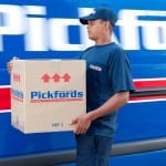 Packer from Pickfords carrying a box for transport.