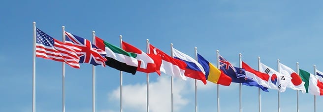 National flagpoles of different countries next to each other.