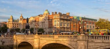 Traditional stone bridge in a picturesque Irish town A charming, historic town in Ireland featuring a stone bridge crossing a peaceful river, capturing the inviting atmosphere of the Irish countryside.