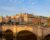A charming, historic town in Ireland featuring a stone bridge crossing a peaceful river, capturing the inviting atmosphere of the Irish countryside.
