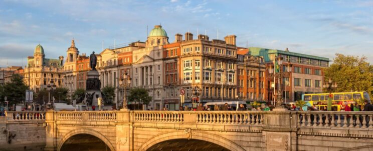 A charming, historic town in Ireland featuring a stone bridge crossing a peaceful river, capturing the inviting atmosphere of the Irish countryside.